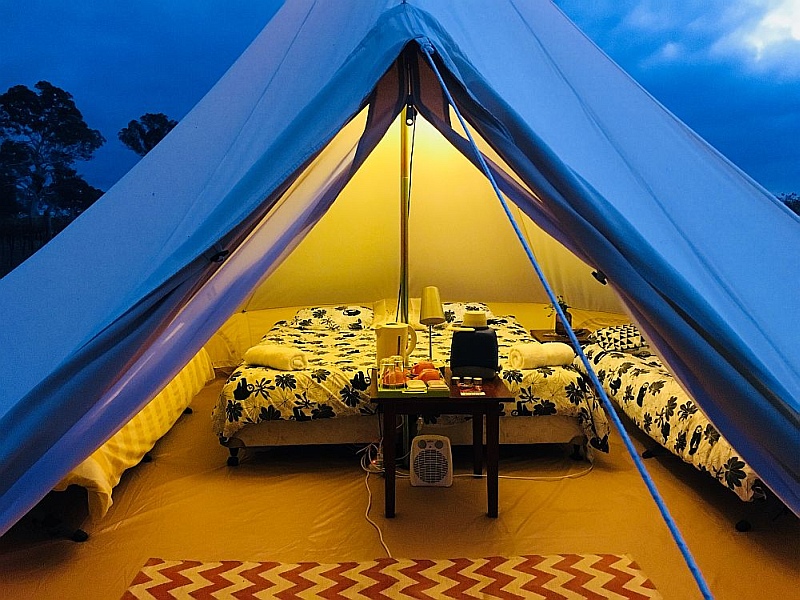 Glamping bell tent lit up from inside